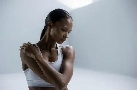 woman-with-her-arms-crossed-white-background-with-white-background 1