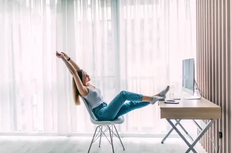 young-female-freelancer-stretching-relaxing-working-laptop-home-office-1-1